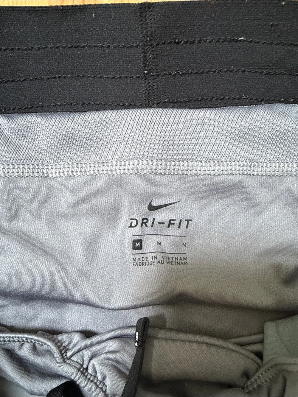 Nike Gray Athletic Shorts with Black Waistband and White Swoosh